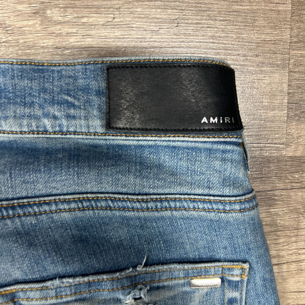 Amiri jean blue oblique white logo distressed