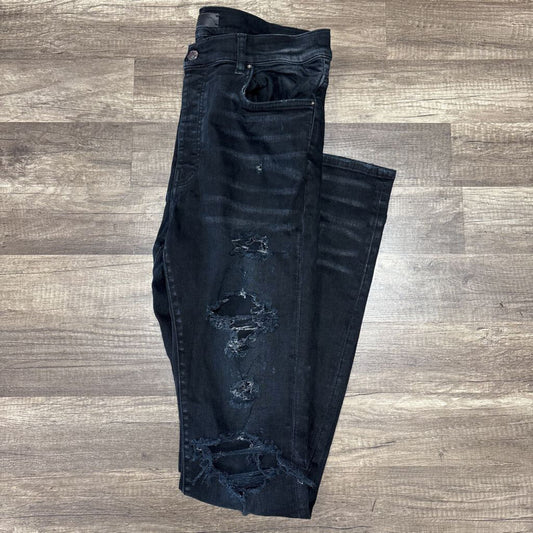 Amiri jean distressed oblique logo black