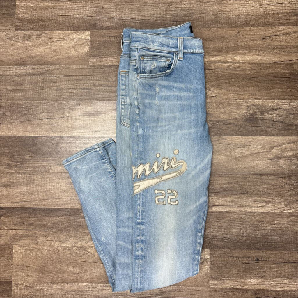 Amiri Jean white oblique logo