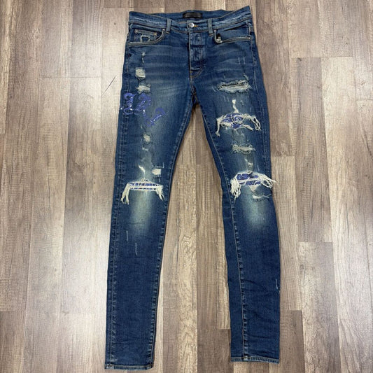 Amiri Jean Old English Oblique Logo