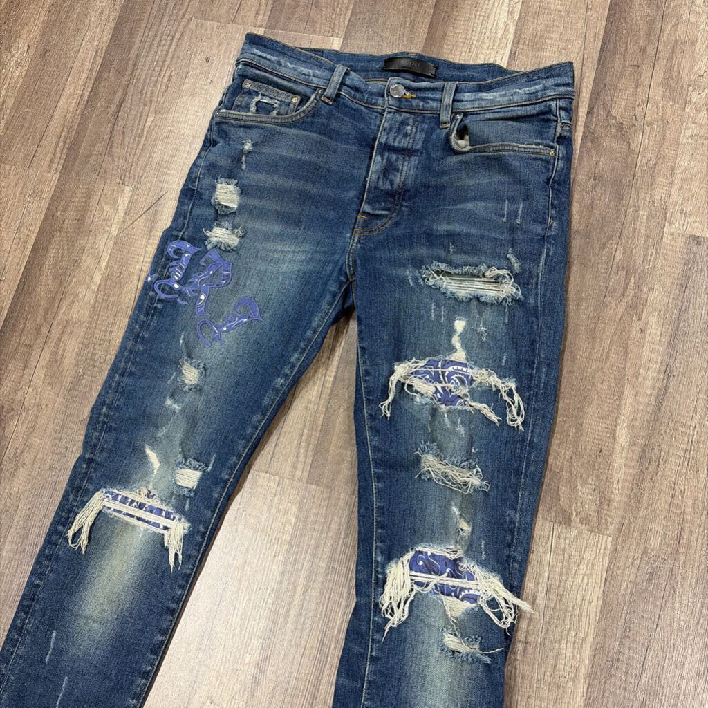 Amiri Jean Old English Oblique Logo